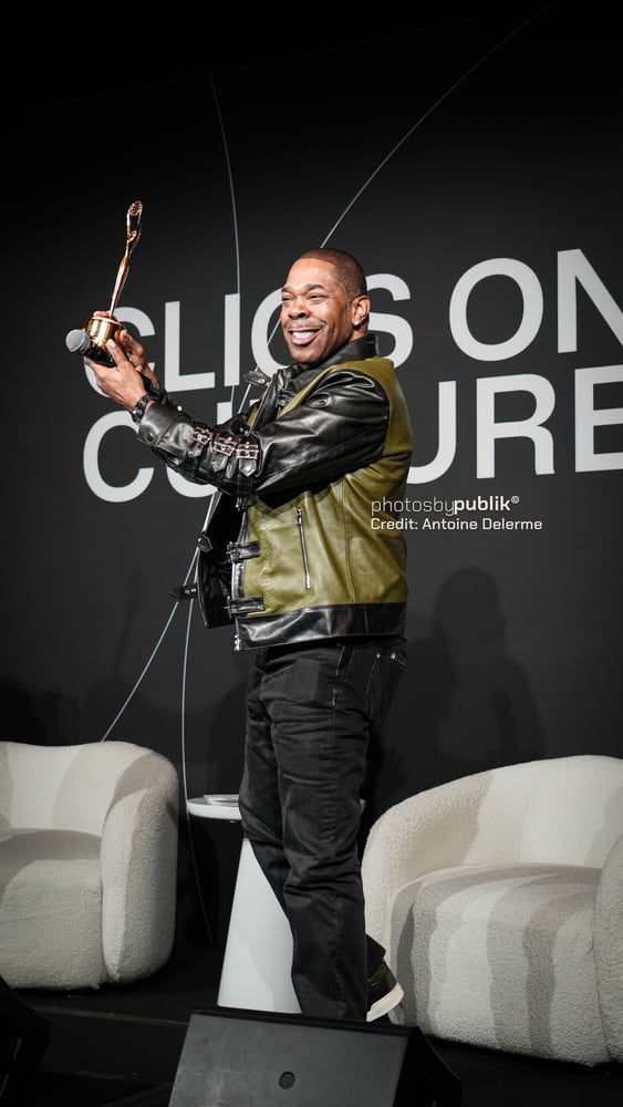 Busta Rhymes holding his Clio award, shot by Photos by Publik